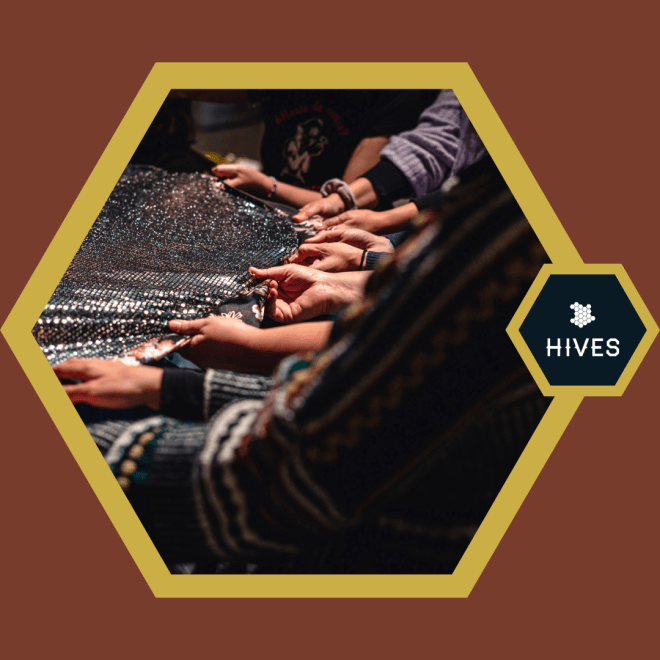 Inside of a brown background and gold frame, many hands touch a woven fabric that looks slightly rough to the touch.